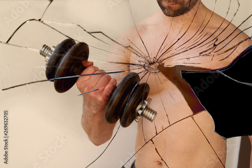 Broken into many fragments image of a man with a dumbbell, the concept of destruction photo