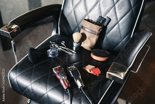 Vintage barber shop hairdresser tools equipment on leather chair background