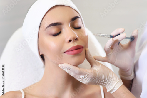Beautician doctor cosmetologist at work. Biorevitalization cosmetology injection. Face skin treatment hyaluronic acid. Beauty facial filling. Filler. Botox procedure. Healthcare beauty concept photo