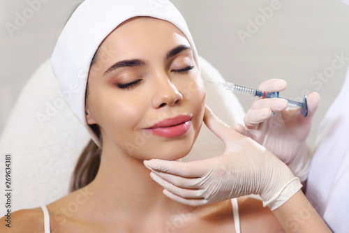 Beautician doctor cosmetologist at work. Biorevitalization cosmetology injection. Face skin treatment hyaluronic acid. Beauty facial filling. Filler. Botox procedure. Healthcare beauty concept