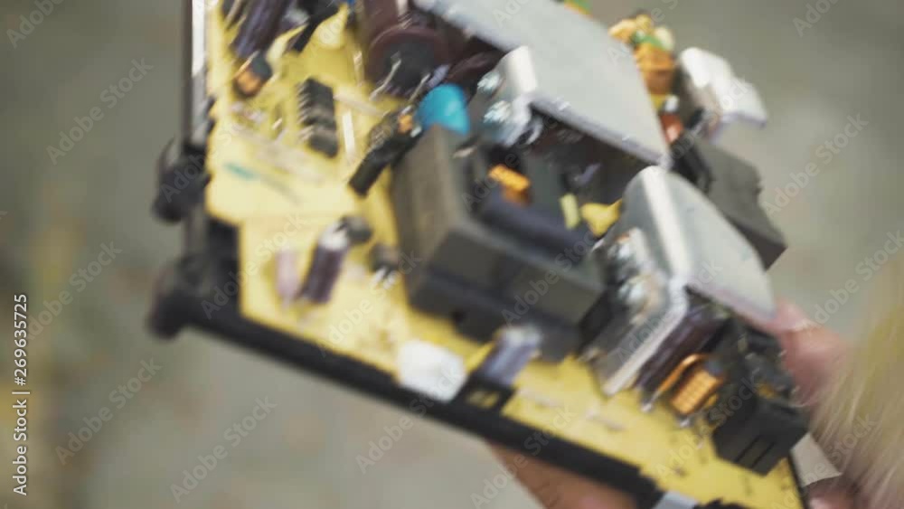 Man cleans the computer board from dust with a brush Man cleans the computer board from dust with a brush