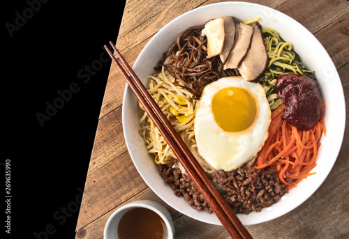 Korean traditional dinner with vegetables and egg on top photo