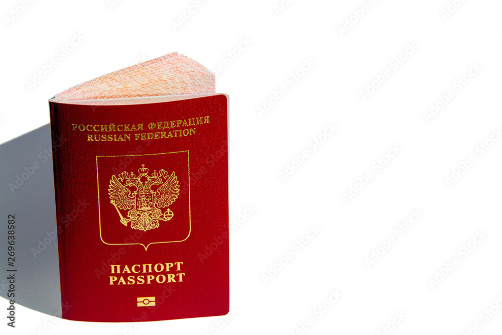 The concept of the passport as a symbol of the state, as well as travel, advocacy, health, pension reform. Passport close-up with the coat of arms on the cover on a white background. Copyspace. The concept of the passport as a symbol of the state, as well as travel, advocacy, health, pension reform. Passport close-up with the coat of arms on the cover on a white background. Copyspace.