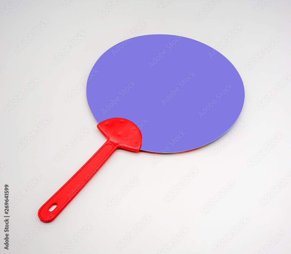 Hand holding red and blue plastic fan isolated on white Hand holding red and blue plastic fan isolated on white