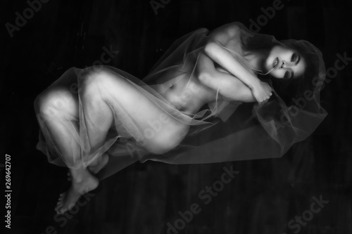 nude portrait of Asian model on wooden floor