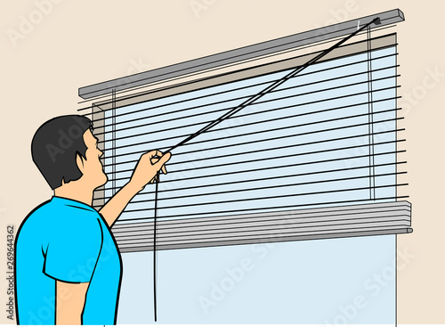 man opening a blind in the window