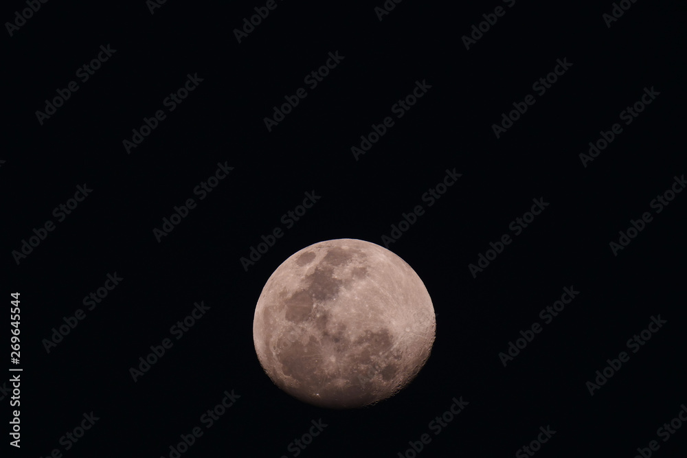 Big moon in its full phase with detailed craters visible on its edges, all in a black background Big moon in its full phase with detailed craters visible on its edges, all in a black background