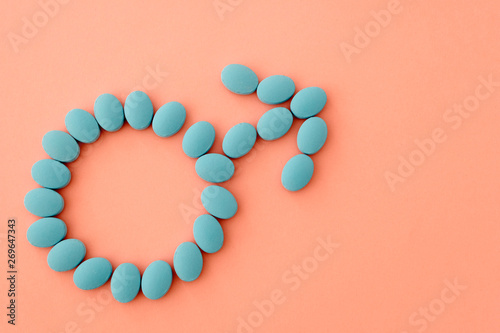 Photos The sign of the man from the pills is blue on a pale pink background