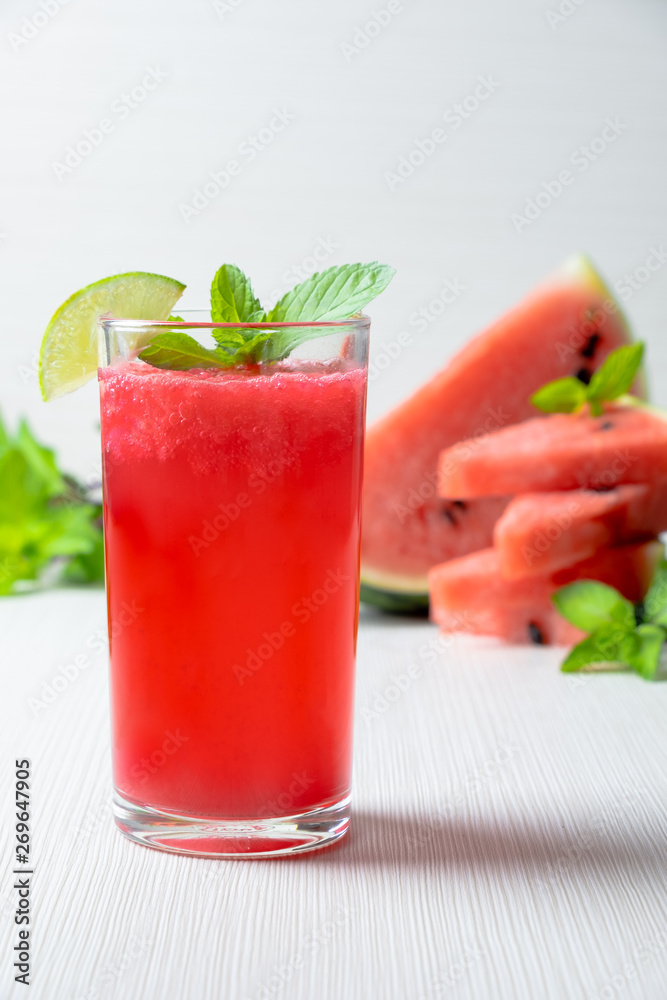 watermelon juice smootie with lemon sliced and mint on white wood texture.studio lighting. home made watermelon concept. watermelon juice smootie with lemon sliced and mint on white wood texture.studio lighting. home made watermelon concept.