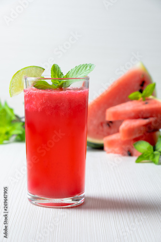 watermelon juice smootie with lemon sliced and mint on white wood texture.studio lighting. home made watermelon concept.