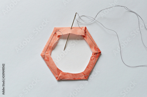 Hexagon template and needle over white