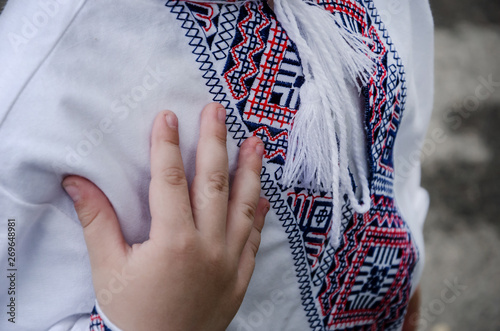 Children's embroidery. Child's hand on the chest. I love Ukraine. Close-up.
