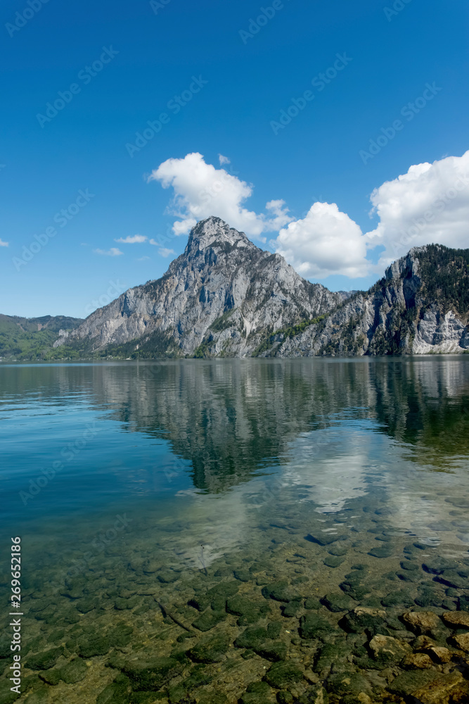 Traunstein Mountain reflection  and clear water in Lake Traunsee, Austria