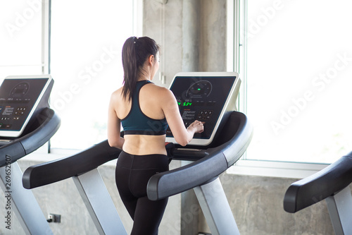 Group of running women on treadmill in fitness gym