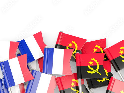 Pins with flags of France and angola isolated on white.