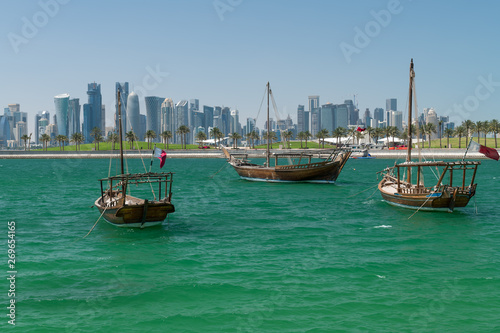 Old fisherman ships in the water in the background the West Bay of Doha, Qatar