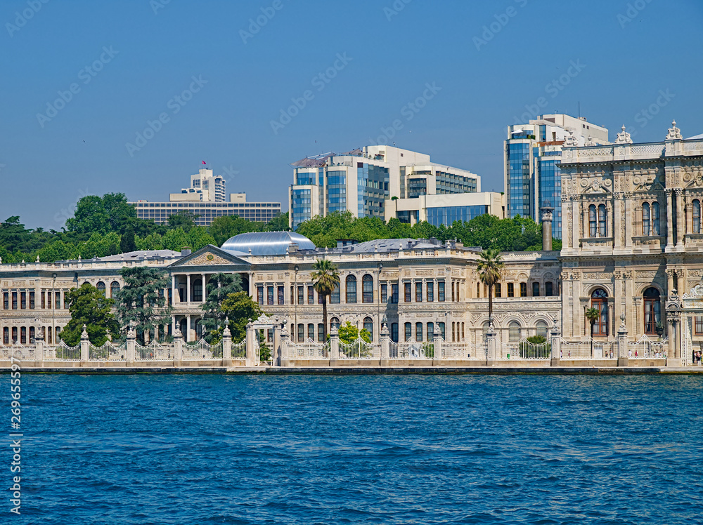 Dolmabahce palace exterior and skyscrapers view from sea. Istanbul, Turkey.