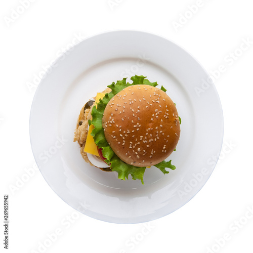 hamburger with lettuce in a plate on a white background, top view