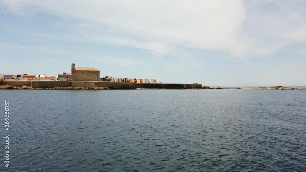 The village on the small Spanish island of Tabarca in the Mediterranean off the coast of Alicante to see from the boat. The weather is nice, the water is blue and the sun is shining. The village on the small Spanish island of Tabarca in the Mediterranean off the coast of Alicante to see from the boat. The weather is nice, the water is blue and the sun is shining.