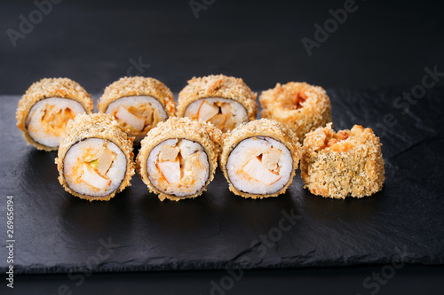 Japanese sushi tempura maki chicken and tamago roll on slate. Japanese traditional fusion food style, restaurant menu