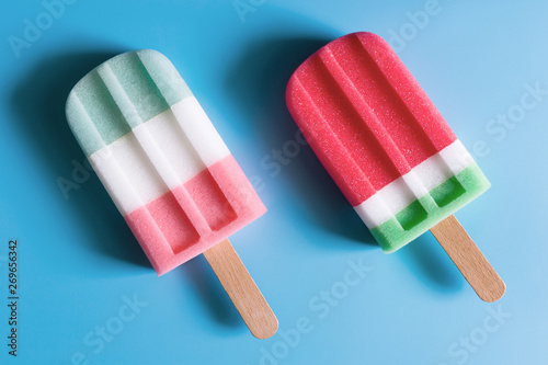 Wallpaper Mural Flat lay of colorful ice cream on the modern rustic on blue background at home office desk wallpaper, top view colorful ice cream pattern on blue pastel background. Minimal summer concept. Torontodigital.ca