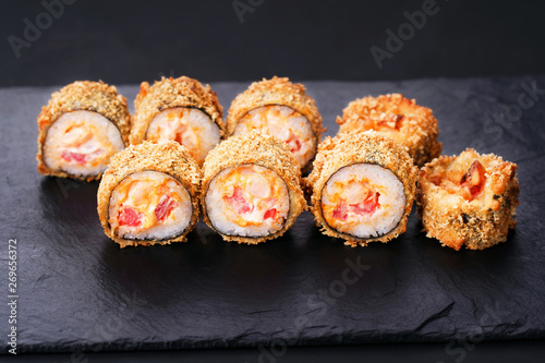 Japanese sushi tempura maki spicy salmon roll on slate. Japanese traditional fusion food style, restaurant menu