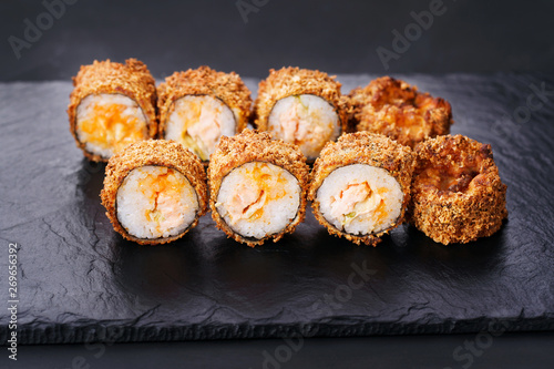 Japanese sushi tempura maki spicy crab roll on  slate. Japanese traditional fusion food style, restaurant menu