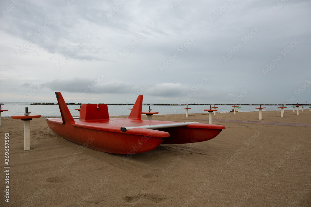 Lifeguard rescue vessel in a beach in the Riviera Romagnola area: italian bay watch Lifeguard rescue vessel in a beach in the Riviera Romagnola area: italian bay watch