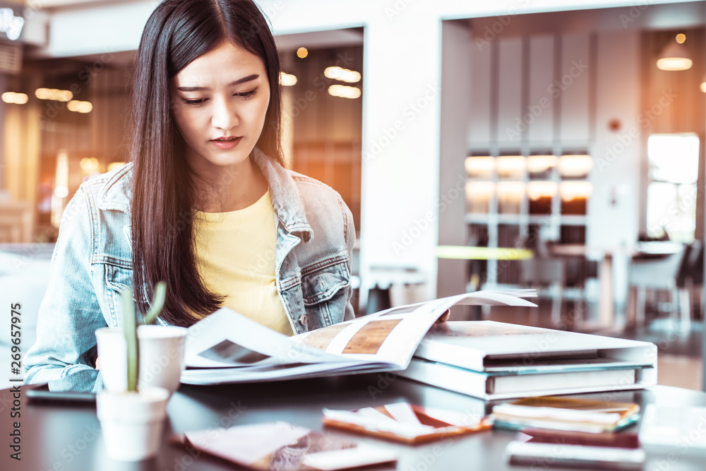 Asian woman in a cafe drinking coffee .Portrait of Asian woman smiling in coffee shop cafe vintage color tone. Asian woman in a cafe drinking coffee .Portrait of Asian woman smiling in coffee shop cafe vintage color tone.