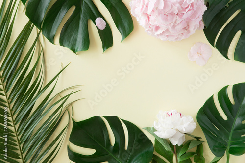Creative layout and background made of tropical palm leaves and pink pastel f...