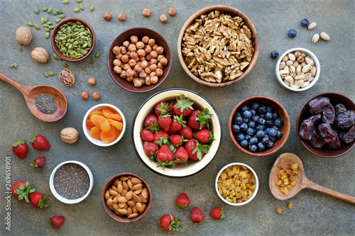 Set of berries, nuts and dry fruits in bowls for a healthy lifestyle. Healthy eating concept