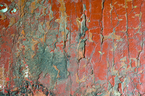 Old cracked red paint, abstract background texture.