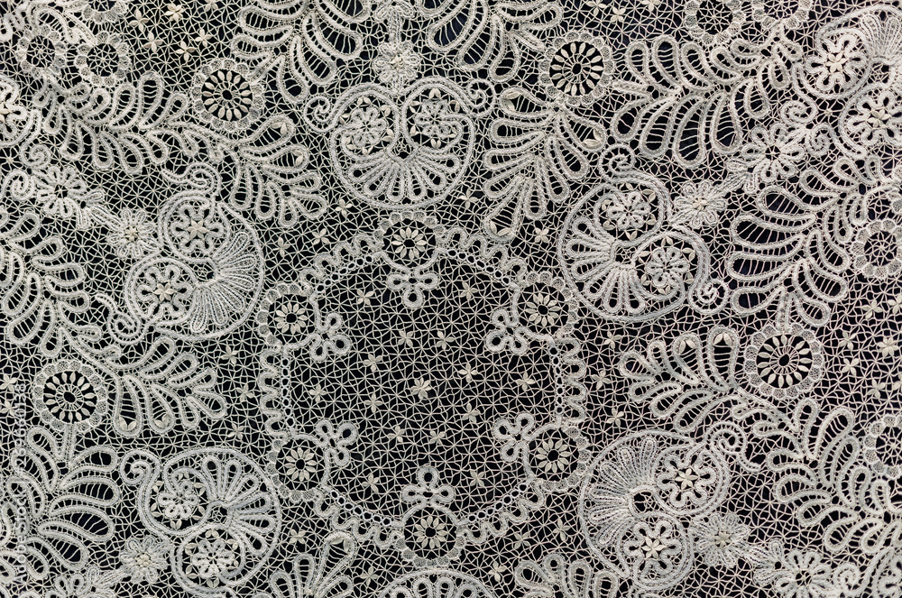 Openwork fragment of Vologda lace on a black background Openwork fragment of Vologda lace on a black background