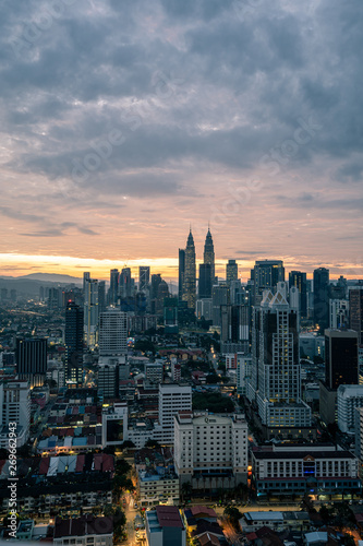 KUALA LUMPUR  MALAYSIA - February 20 2019  Petronas Twin Towers just before sunrise with a bright moody sky.