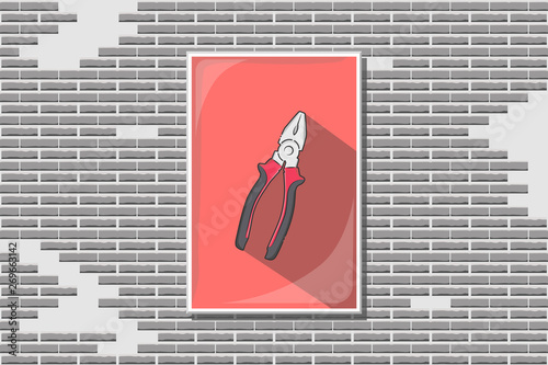 One picture of new metal pliers with rubber or plastic handle of red and black colors and long shadow in rectangular frame with glass on old broken bricks wall