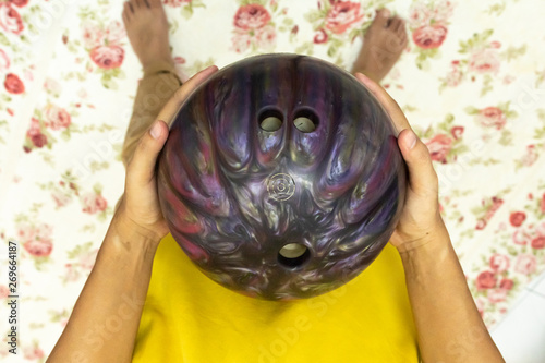 Point of view hand holding bowling ball