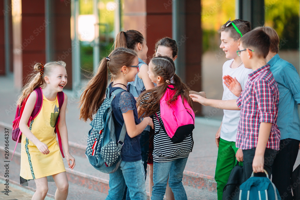 Schoolmates go to school. Students greet each other.