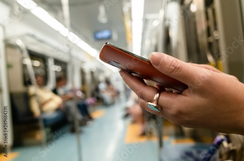 using smartphone at the MRT carriage