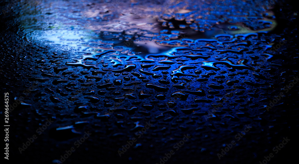 Wet asphalt, night scene of an empty street with a little reflection in the water, the night after the rain. Abstract dark neon background with a wet surface, reflection, neon, glare, blurred bokeh. Wet asphalt, night scene of an empty street with a little reflection in the water, the night after the rain. Abstract dark neon background with a wet surface, reflection, neon, glare, blurred bokeh.