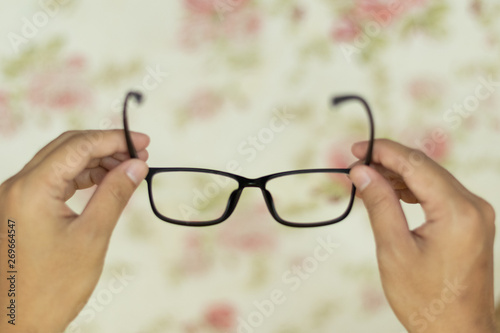 Point of view hand holding eye glasses