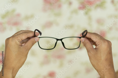 Point of view hand holding eye glasses