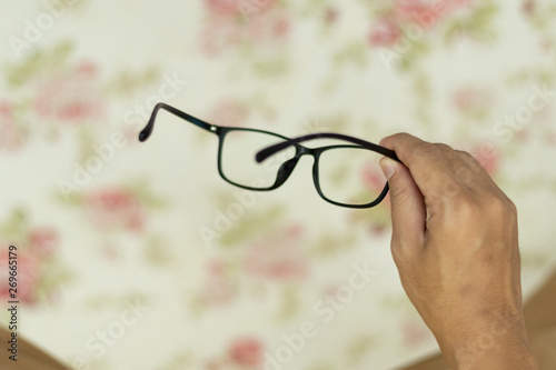 Point of view hand holding eye glasses