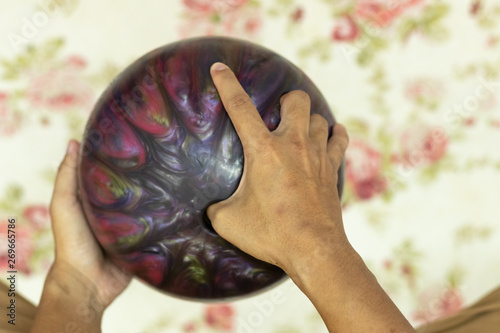 Point of view hand holding bowling ball