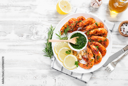 Grilled tiger shrimp with parsley sauce and lemon. photo