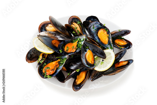 Delicious seafood mussels with parsley sauce and lemon. isolated on white background