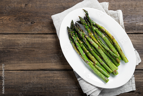 Grilled green asparagus on white plate. top wiew photo