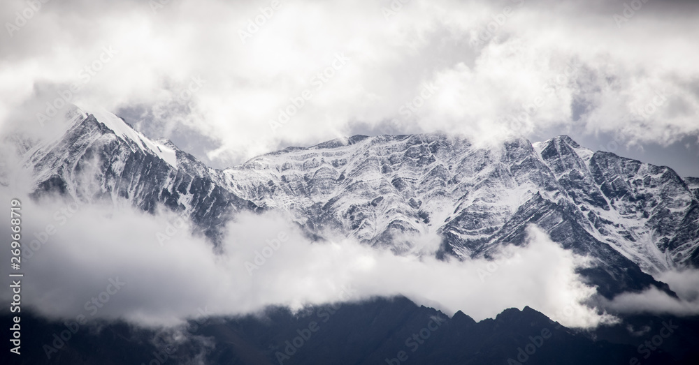 Amazing snowy clad peaks with majestic clouds Amazing snowy clad peaks with majestic clouds
