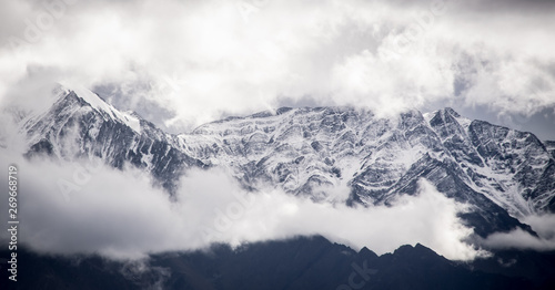 Amazing snowy clad peaks with majestic clouds