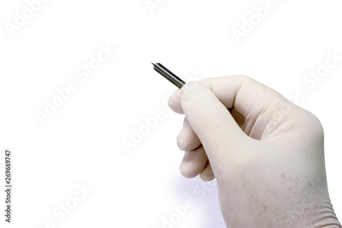 Hand of doctor in white medical glove holding blood lancet stab on human forefinger to check glucose in the blood isolate on white background and make with paths. photo
