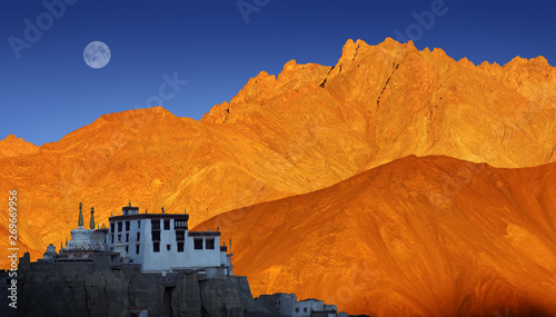 Lamayuru Buddhist monastery, scenic mountain view with full moon and sunset, Ladakh, India photo